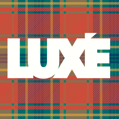 Guy on a bike ok a wooden bridge with a forest backdrop